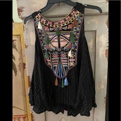 Black Full Fitting Top Has Gold Thread Design Wt Colors Of Stitching Very Pretty Excellent Condition Embroidered Black Blouse For Beach, Embroidered Black Beach Blouse, Black Fitted Bohemian Tops, Fitted Black Bohemian Tops, Black Bohemian Blouse For Party, Black Embroidered Festival Tops, Black Sleeveless Bohemian Blouse, Bohemian Black Sleeveless Blouse, Bohemian Sleeveless Black Blouse