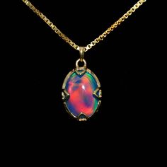 Stunning Lab-Created Opal Pendant Necklace Product: 11141 Dimensions: Approximately 20 mm x 15 mm x 7 mm Weight: 13 cts. This stunning lab-created opal pendant, or synthetic opals, is a man-made gemstone. Lab-created opals have the same physical properties, chemical composition, and appearance as natural opals. Lab-created opals often mimic the natural opal formation process in a concentrated period. The pendant is made of .925 sterling silver with yellow-gold rhodium plating. Rhodium plating is a thin layer of rhodium coated onto a base metal, such as silver, gold, or another alloy. This gives jewelry extra strength and luster. Rhodium plating is shinier and more durable than other metals. It doesn't scratch, dent, or corrode and retains its luster. Rhodium is one of the rarest precious m Round Opal For Jewelry Making, Oval Opal Jewelry Collectible, Ethiopian Opal Oval Pendant Jewelry Gift, Ethiopian Opal Oval Pendant With Gemstone, Iridescent Opal Round Jewelry, Formal Opal Pendant Jewelry, Iridescent Round Opal Jewelry, Ethiopian Opal Oval Pendant, Iridescent Opal Jewelry