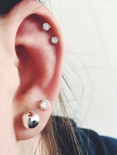 an ear with three piercings attached to it, and the caption says i'm uploaded by casey p