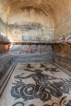 an ancient mosaic floor in the middle of a tunnel