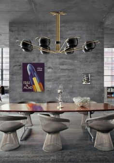 an elegant dining table with four chairs and a chandelier hanging from the ceiling