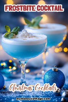 two blue christmas cocktails with mint garnish on the rim