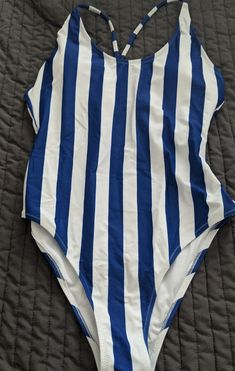 Brand New Blue And White One Piece Swimsuit Striped Sleeveless Summer Bodysuit, Sleeveless Striped Bodysuit For Pool, Blue Sleeveless Bodysuit For Beach Season, Striped Summer Bodysuit For Beach Season, Spring Striped Bodysuit For The Pool, Striped Stretch Bodysuit For Summer, Striped Stretch Summer Bodysuit, Blue Sleeveless Bodysuit For Poolside, Sleeveless Blue Bodysuit For Poolside