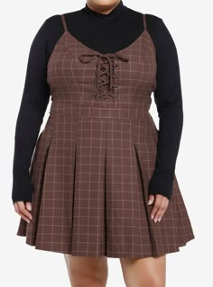 Class is in session! Get the dark academia look with this twofer dress! Featuring a brown plaid dress with lace-up detailing at the chest and a pleated skirt. Comes with a black mock neck long-sleeve underneath  adjustable straps  side zipper and pockets.Please note: Dress is fitted with no stretch; size up for a looser fit.65% polyester; 35% rayonWash cold; dry lowLength: 40''ImportedModel is 5'10''Model wears size 1 Fashion For Chubby Ladies, Plus Size Cottagecore Fashion, Plus Size Pastel Goth, Plus Size Alt Fashion, Brown Plaid Dress, Plus Size Cottagecore, Academia Look, Dark Academia Look, Twofer Dress