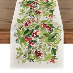 a table runner with holly and berries on it