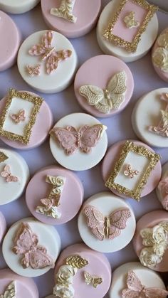 some pink and white buttons with gold designs on them