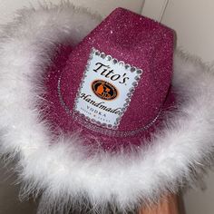 a pink hat with white fur around it