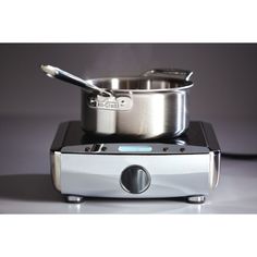 a stainless steel pot and pan sitting on top of a stove