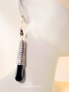 Retro inspired black onyx earrings accented in antique silver by Designed by Audrey.  I crowned sparkling elongated 30x10mm black onyx tear drop beads with heavy metal antique silver bead caps which are heavily embossed in rows and rows of graduated spikey beads. These earrings are 3 inches in length from the top of the antique silver Bali styled fleur de lis French earring wire.  Make a bold fashion statement with these long and lovely black and silver earrings.  Item # 320E-ETo My Internationa Nickel Free Black Long Drop Earrings, Nickel-free Black Long Drop Earrings, Nickel-free Black Long Drop Jewelry, Silver Onyx Teardrop Earrings, Silver Teardrop Jewelry With Black Enamel, Elegant Teardrop Black Bead Earrings, Elegant Black Metal Teardrop Earrings, Elegant Black Beaded Teardrop Earrings, Black Metal Drop Earrings