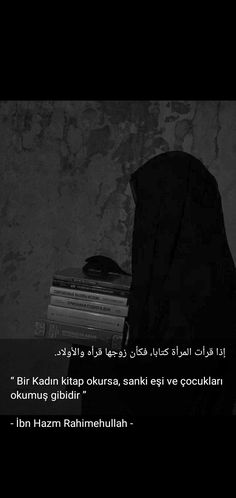 a black and white photo with a person in a hijab looking at books