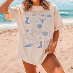 Coastal Cowgirl Shirt, perfect for any beach vacation. SIZING This is a unisex shirt. Unisex is a traditional fitted men's t-shirt size, but they look great on women. * Women may order 1 size down if they prefer a slimmer fit. * Please size up for the over-sized look MATERIALS Comfort Colors are the ultimate when it comes to soft and comfortable Tshirts. They are made from 100% ring-spun cotton. The soft-washed, garment-dyed fabric brings extra coziness to your wardrobe while the relaxed fit mak Beach Themed Shirts, Western Style Short Sleeve Summer Tops, Western Cotton Tops For Summer, Western Style Graphic Print Summer Top, Western Tops With Graphic Print For Summer, Western Style Graphic Print Tops For Summer, Western Style Summer Tops With Letter Print, Western Style Relaxed Fit Summer Tops, Coastal Cowgirl Birthday