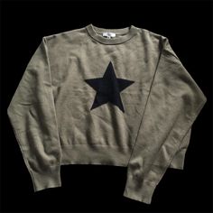 a gray sweatshirt with a black star on it