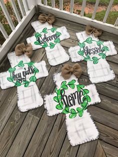 four personalized towels on a deck with bows