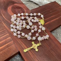 This unique precious handmade catholic rosary is made with gold filled wire and chain and natural 6,8mm pink quartz beads, gold plated Sacred Family/ Holy Spirit centerpiece and Saint Benedict cross. The quartz beads are 100% natural. Each item is send in a small organza bag. Gold Rosary With Gemstone Beads Gift, Gold Rosary With 8mm Beads For Healing, Gold Spiritual Rosary With Gemstone Beads, Gold Gemstone Beads Rosary, Handmade Gold Rosary For Healing, Handmade Gold Healing Rosary, Sacred Family, St Benedict Cross, Saint Benedict