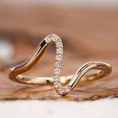 two gold rings with white diamonds on them