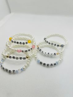 three bracelets with words written on them