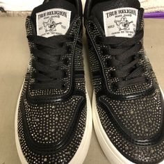 These Adorable Black/Silver True Religion Sneakers Are Perfect For Any Occasion, You Can Wear Them With Jeans, Shorts, Or Even A Dress/Skirt, They Can Be Dressed Up For A Fun Night Out Or Dressed Casually For Everyday Life.. Endless Possibilities.. Casual Sneakers With Rhinestones For Streetwear, Black Sneakers With Rhinestones And Round Toe, Black Rhinestone Sneakers With Round Toe, High-top Bling Sneakers For Streetwear, Bling Sneakers With Round Toe For Streetwear, Sporty Black Sneakers With Rhinestones, Silver Low-top Sneakers With Bling, Trendy Silver Sneakers With Bling, Silver Bling Low-top Sneakers