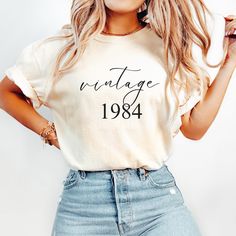 a woman wearing a vintage t - shirt with the word'vintage'printed on it