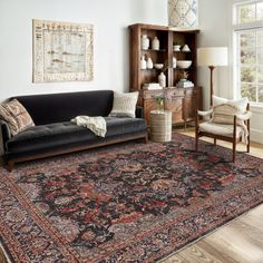 a living room filled with furniture and a large rug