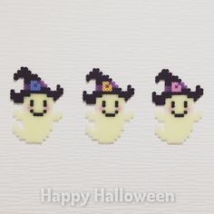 three pieces of pixel art with the words happy halloween written on each piece in front of them