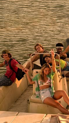 a group of people riding on the back of a boat