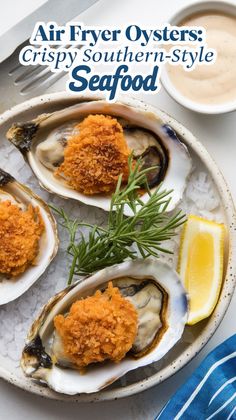 three oysters are on the plate with lemon wedges and some sauce next to it