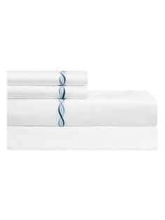 two white sheets with blue lines on the bottom and one in the middle, are folded up