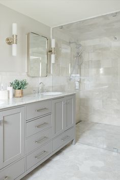 a bathroom with two sinks and a large mirror on the wall next to each other