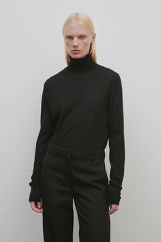 Eva Top in Cashmere $1,290 Black Long Sleeve Cashmere Turtleneck, Black Cashmere Long Sleeve Turtleneck, Fine Knit Funnel Neck Sweater For Work, Workwear Fine Knit Funnel Neck Sweater, Black Cashmere Turtleneck Tops, Black Merino Wool Turtleneck For Fall, Luxury Black Wool Top, Black Cashmere Turtleneck With Funnel Neck, Black High Neck Cashmere Top