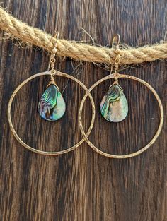 These Beautiful hand Crafted hoop earrings were hand forged and texturized with 14k Gold Filled Wire.  I then lovingly hung beautiful iridescent teardrop abalone beads.  Also available in Sterling Silver & Rose Gold Filled.  Custom creations are available as well just send me a message☺️ A great gift for a loved one or even for yourself❤️ Teardrop Wire Wrapped 14k Gold Filled Hoop Earrings, Teardrop 14k Gold Filled Wire Wrapped Hoop Earrings, 14k Gold Filled Teardrop Earrings, Teardrop 14k Gold Filled Hoop Earrings, Handmade Teardrop Abalone Shell Jewelry, Wire Wrapped Teardrop Hoop Earrings, Hammered 14k Gold-filled Teardrop Jewelry, Abalone Shell Dangle Jewelry, Gold Abalone Shell Round Jewelry