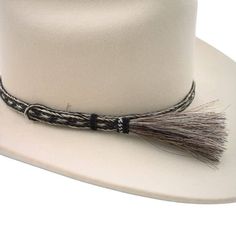 Enhance your hat with the natural elegance of the Pepper Horsehair Braided Single Tassel Hat Band. Made from 100% genuine horsehair, this beautifully crafted hat band combines durability with sophisticated style. Handmade with precision, it features a 3/8 inch width and an adjustable design to fit most hat sizes comfortably. The single tassel adds a unique touch, making this hat band a standout accessory. Please note that the hat is not included with the purchase of this hat band. Elevate your h Elegant Adjustable Fedora For Western-themed Events, Elegant Brown Hat Band For Ranch, Elegant Adjustable Rodeo Hat, Elegant Adjustable Hat For Rodeo, Elegant Adjustable Beige Hat Bands, Elegant Adjustable Hat For Western-themed Events, Elegant Fur Felt Fedora For Ranch, Adjustable Flat Brim Hat With Fringe, Adjustable Fringe Hat With Curved Brim