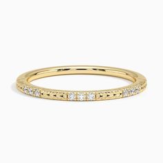 a yellow gold band with diamonds on it