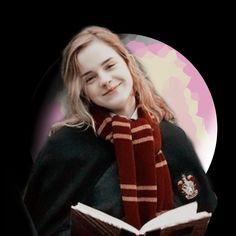 a woman wearing a harry potter scarf and holding an open book