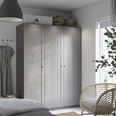 a bedroom with white furniture and grey walls