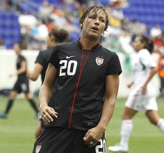 a soccer player is standing on the field