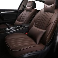 the interior of a car with brown leather upholstered seats and black steering wheel covers