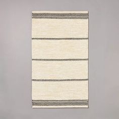 a black and white rug hanging on the wall