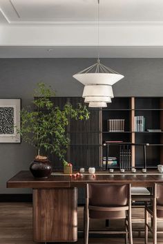 a dining room table with chairs and bookshelves