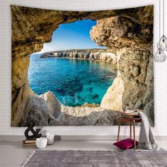 an ocean view through a cave wall tapestry