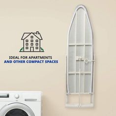 a laundry room with an ironing board next to a washer and dryer