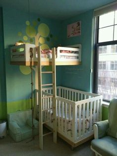 a baby's room with a bunk bed, chair and crib in it