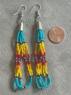 These beaded earring are made by me a Native American from the Rosebud Reservation. The primary color is turquoise blue with silver accent beads mixed with fire colors. There are variations with the designs although some designs are similar.  I will post the variations separately. Native American Seed Bead Bracelet, Southwestern Style Multicolor Tiny Beads Earrings, Southwestern Multicolor Round Bead Earrings, Adjustable Multicolor Earrings With Spacer Beads, Multicolor Drop Earrings With Spacer Beads, Southwestern Multicolor Tiny Beads Earrings, Southwestern Multicolor Nickel-free Beaded Earrings, Southwestern Style Multicolor Nickel-free Beaded Earrings, Southwestern Blue Beaded Earrings With Round Beads