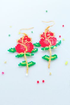 two red roses are made out of beads