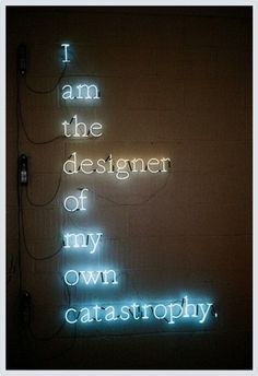 a neon sign that says i am the designer of my own catastrophy