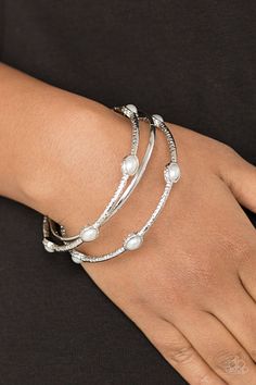 Delicately hammered in shimmer, a pair of pearly white encrusted bangles joins a smooth silver bangle around the wrist for a refined fashion. Sold as one set of three bracelets. Live Text, Pearl Bangle Bracelet, Silver Strand, Refined Fashion, Pearl Bangle, White Bracelets, Paparazzi Accessories, Blue Gems, Silver Bangle