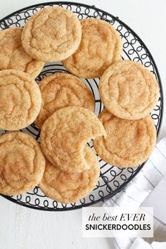 some cookies are on a black and white plate with the words, the best ever snickkerdoodlees