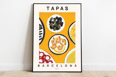 a poster with some food on it in front of a wall that says tapas