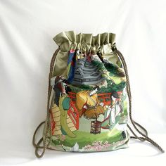 Large drawstring backpack, also known as cinch sack or gym, beach bag. Essential accessory for those who are always on the move.  Characteristics: * Women, girl String bag made of: one part in canvas with oriental motifs, while the other part is made of shiny gold waxed canvas; * Lined interior with a pocket; * Approximate measurements (cm): L 45, H 59. * Drawstring-shoulder straps made of braided nautical rope, which in addition to being aesthetically very beautiful, also has the great advantag Green Bucket Bag For Travel With Dust Bag, Green Bucket Bag With Dust Bag For Travel, Green Bucket Bag Backpack For Daily Use, Casual Beach Tote Backpack, Green Backpack Shaped Bucket Bag For Travel, Handmade Green Backpack For Travel, Casual Pouch Drawstring Bag For Travel, Casual Drawstring Backpack For Travel, Casual Drawstring Pouch Bag For Travel