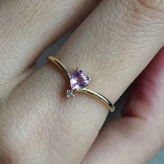 This 14K Pink Sapphire Heart ring makes for a perfect promise ring, or as a gift for your beloved. Nothing like saying "I love you" with this dainty beauty top with a natural white diamond. Perfect to wear alone or stacked with other ring bands. Available in 14k yellow gold, rose gold, and white gold. Pair it with our Siren Marquise ring or Winter Palace Marquise ring (as pictured) for the ultimate majestic look. This ring is designed and made in NYC. 14K solid gold band Natural pink heart sapph Heart Shaped Diamond Ring With Rose Cut For Promise, Dainty 14k Gold Birthstone Ring For Proposal, Heart Shaped Rose Cut Diamond Ring For Gift, Gift Heart Ring With Rose Cut Diamonds, Rose Gold Heart Cut Rings With Rose Cut Diamonds, Rose Gold Rings With Heart-cut Rose Diamonds, Heart Cut Rose Diamonds Heart Ring, Diamond Solitaire Heart Ring For Proposal, Heart Ring With Rose Cut Diamonds For Promise