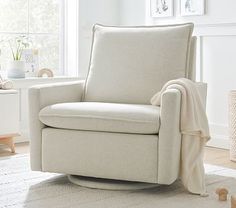 a living room with a white chair and rug